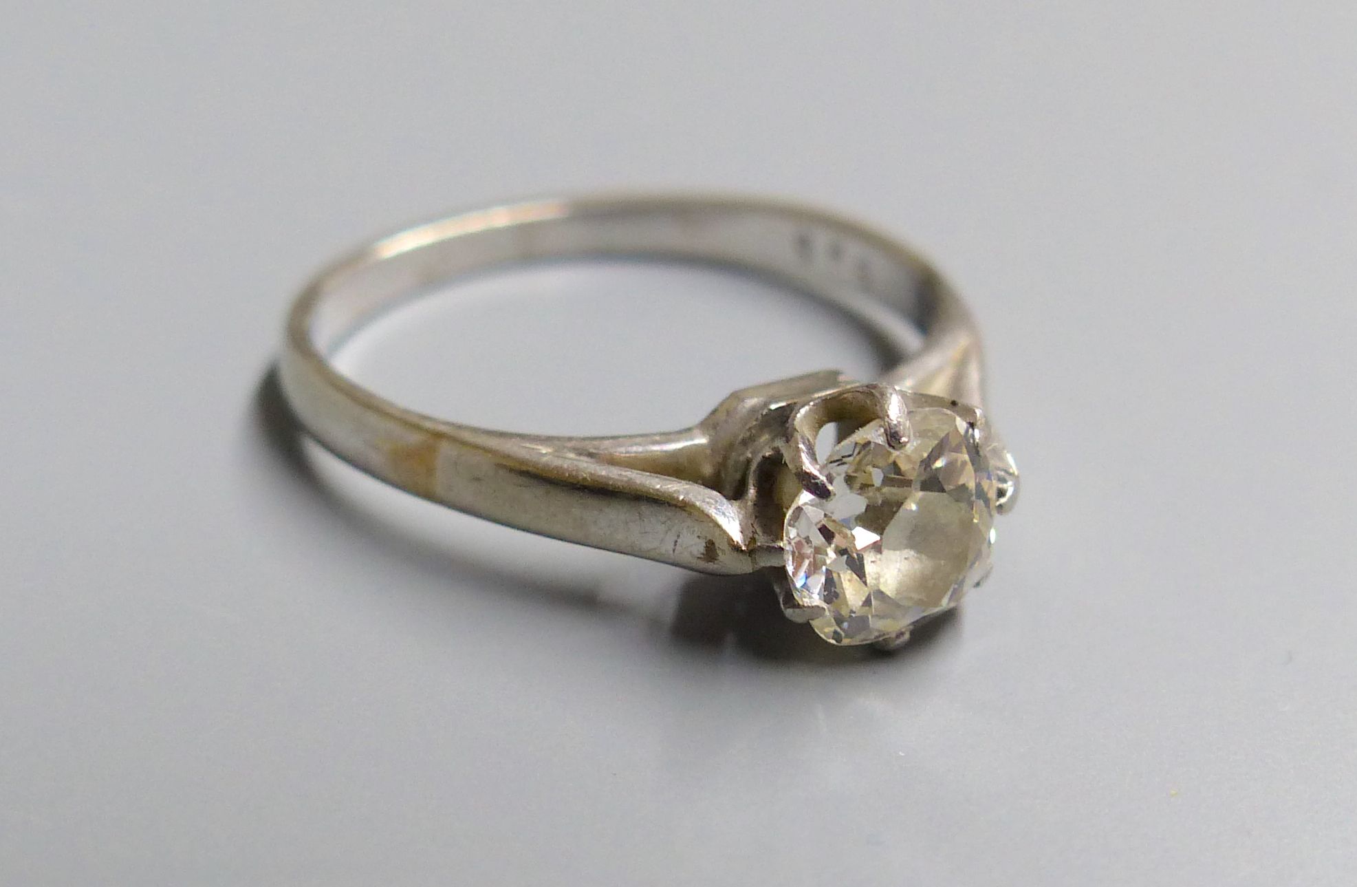 A white metal and old mine cut solitaire diamond ring, size M, gross 2.6 grams,